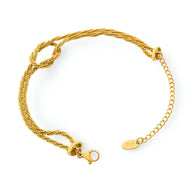 Bracelet en titane plaqué or tressé avec fermeture à mousqueton et chaîne réglable.