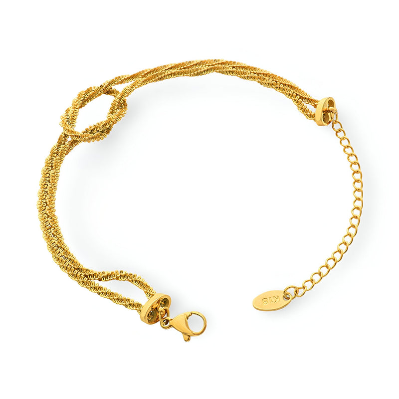 Bracelet en titane plaqué or tressé avec fermeture à mousqueton et chaîne réglable.