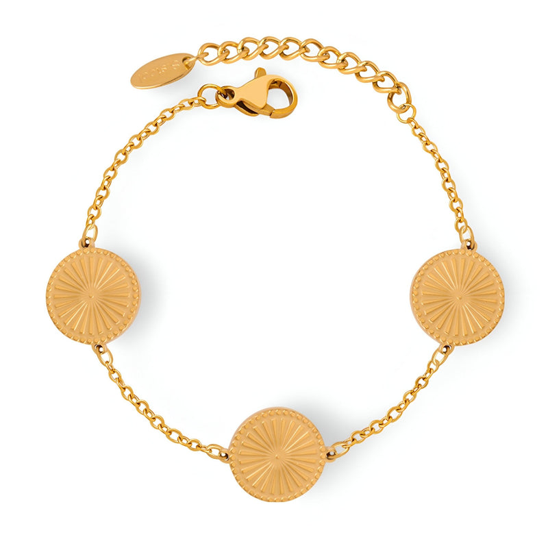 Bracelet fin en titane plaqué or avec trois médaillons rayonnants et chaîne délicate.