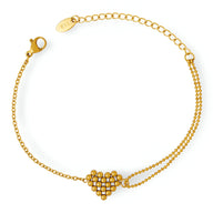 Bracelet en titane plaqué or avec motif cœur formé de perles délicates et chaîne fine ajustable.