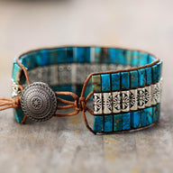 Bracelet multi-rangs femme en pierres naturelles turquoise avec motifs floraux argentés et fermeture bouton gravé.