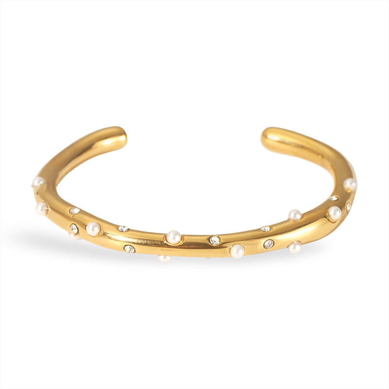 Bracelet jonc or avec perles blanches délicates réparties uniformément.