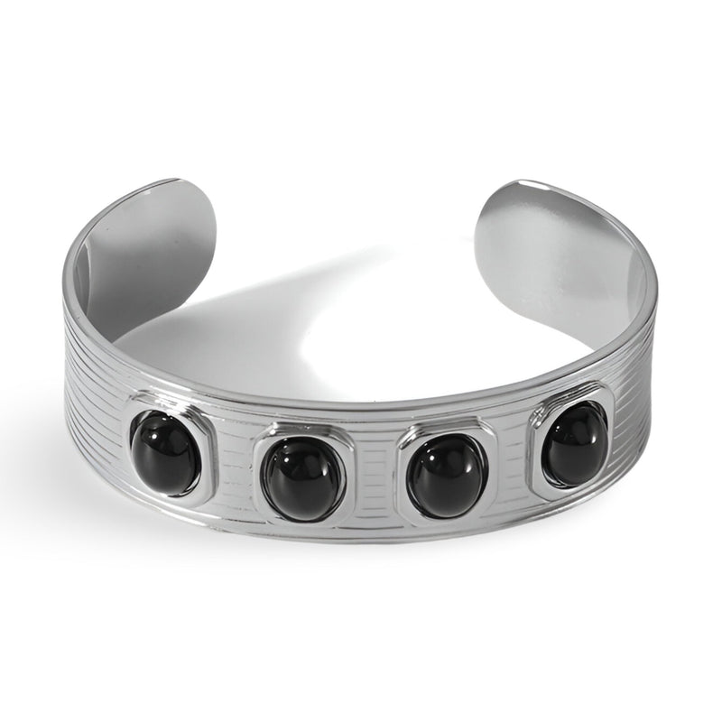 Bracelet jonc argent avec quatre pierres naturelles noires rondes et gravures fines sur le métal.