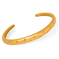 Bracelet jonc rigide plaqué or 18 carats, serti de petits zircons brillants, modèle fin et élégant.